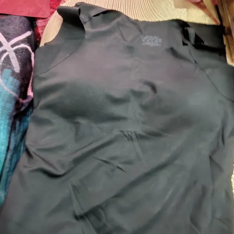 Customer review photo of a dark tank top on patterned fabric