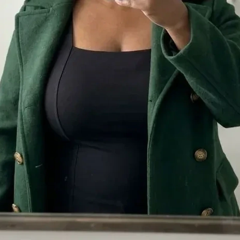 Customer review mirror photo wearing a black tank top and green cardigan