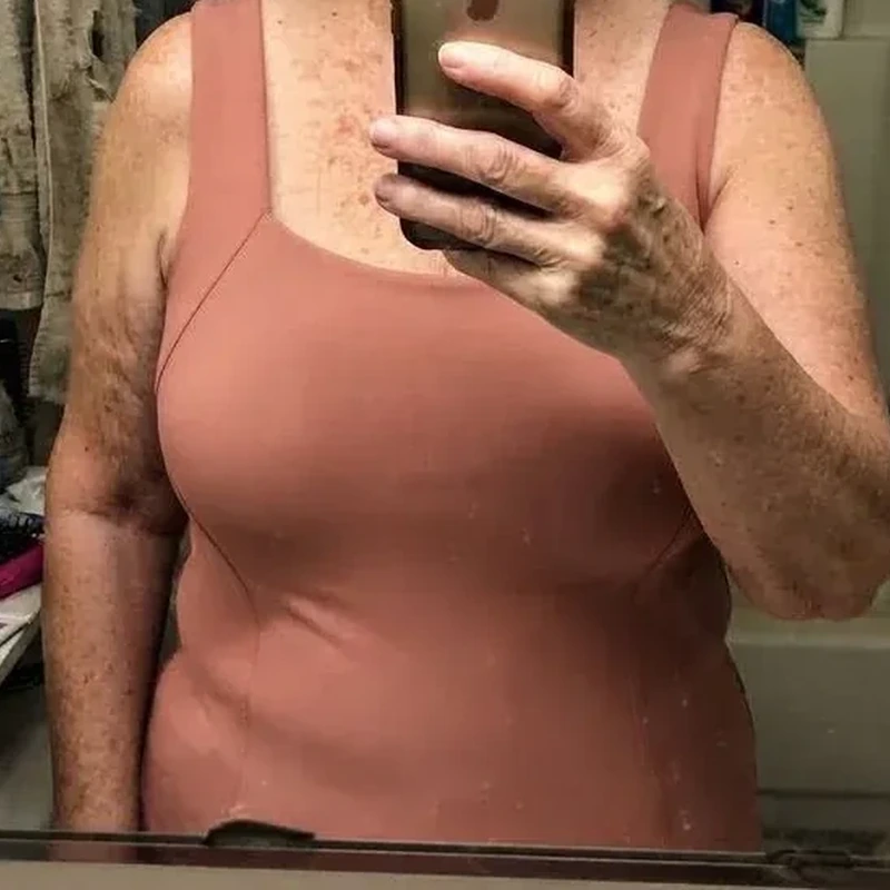Customer review mirror photo wearing a dusty rose tank top